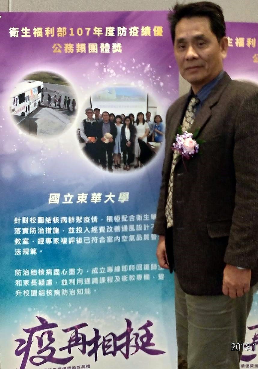 東華大學徐輝明副校長與「疫再相挺」防疫海報合影