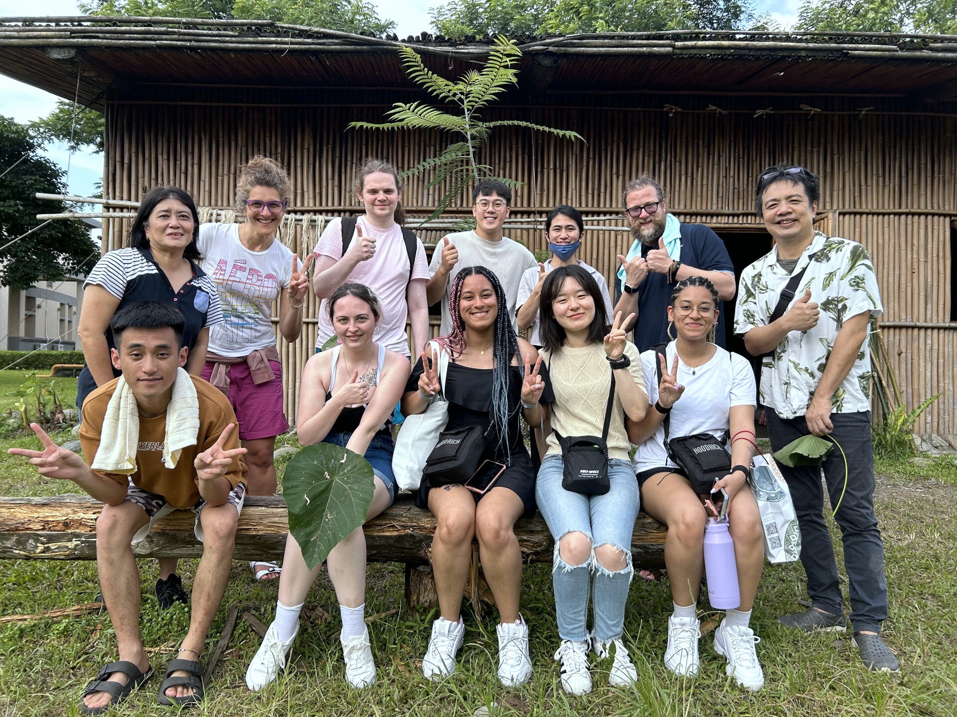 The guests from Central Lancashire University took a group photo at the bamboo and hemp house