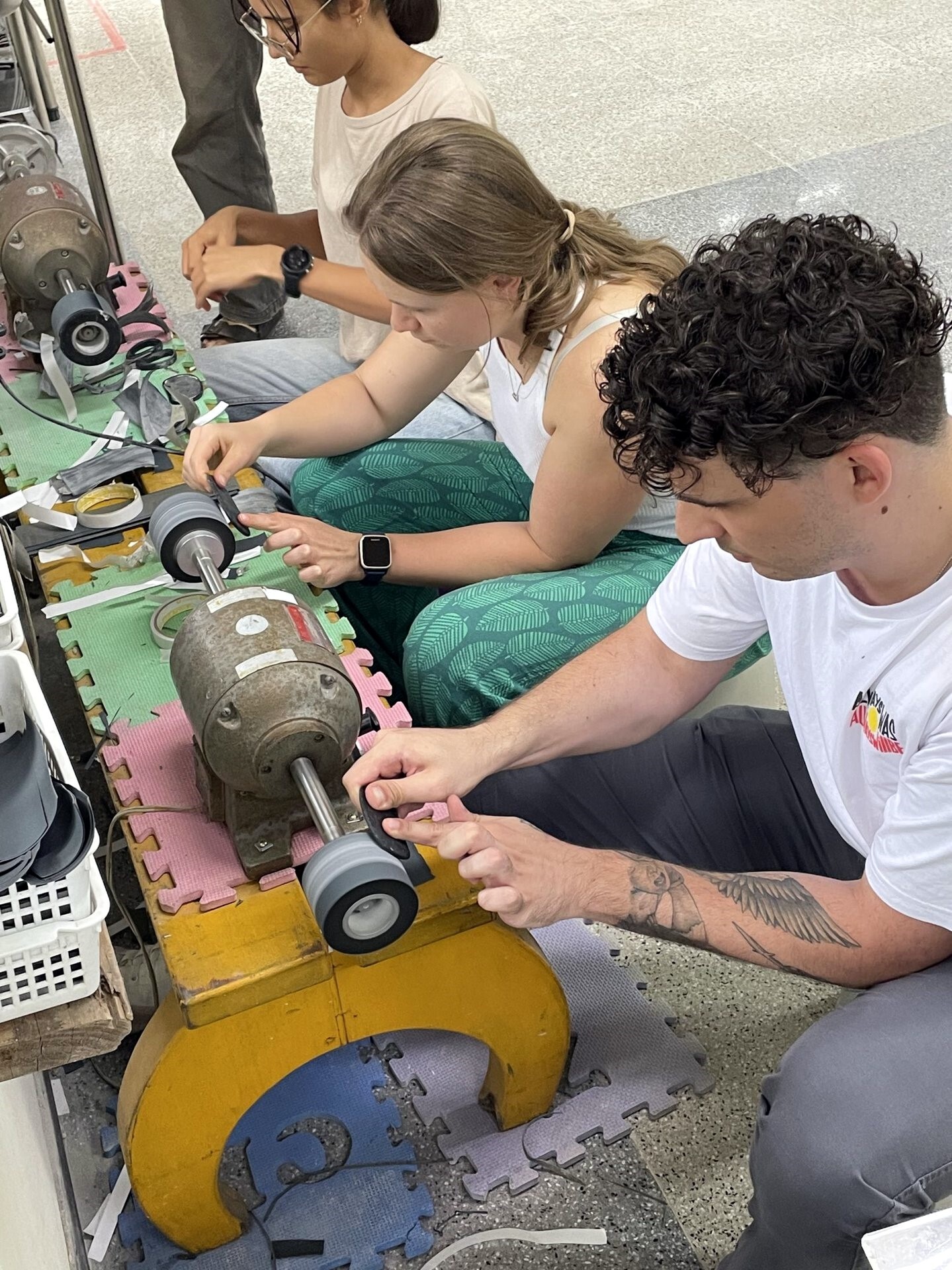 WSU students sanding down local Taiwanese jade pieces during a jade crafting workshop